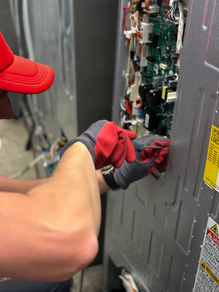 Professional appliance installation services by SMS Appliances in Calgary, Airdrie, Regina, Saskatoon, and Medicine Hat with certified technician installing home appliance safely