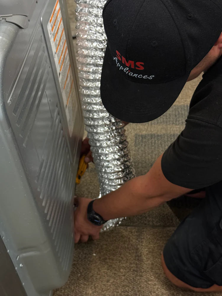 Dryer installation services in Regina by SMS Appliances technician installing a new clothes dryer safely and professionally at customer home