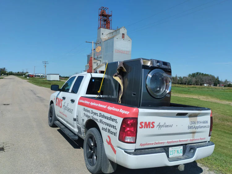 Washer removal services by SMS Appliances team safely removing and hauling away an old washing machine from a customer home